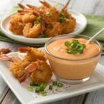 Bang Bang Sauce recipe served with crispy shrimp garnished with fresh herbs